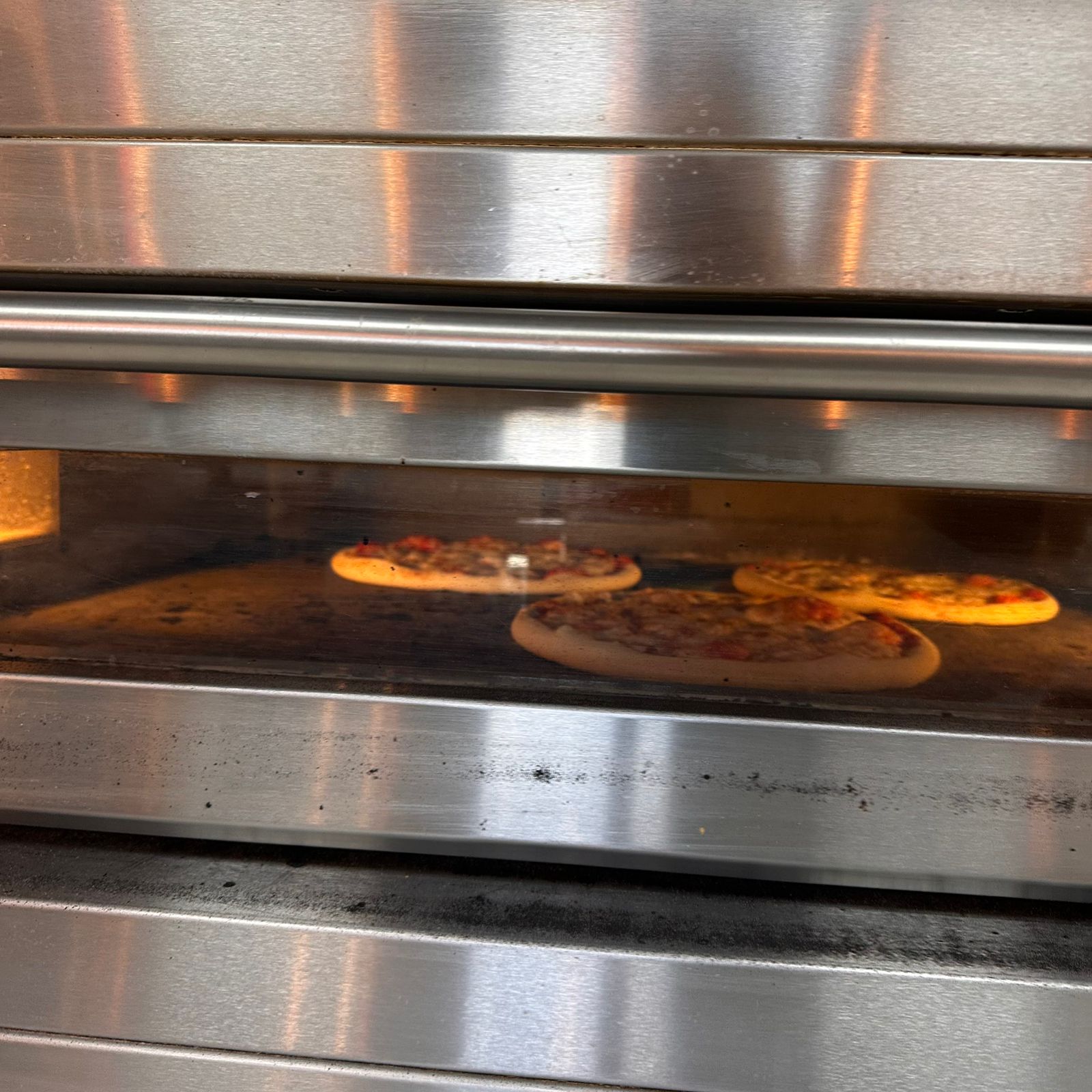 Modern Moretti Forni electric deck oven baking a Neapolitan pizza